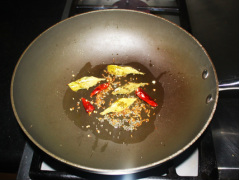 Add red chilies and curry leaves and fry 